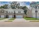 Two-story brick townhome with attached two-car garage and landscaped front yard at 300 Navigator Ln, Mcdonough, GA 30253