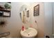 Small bathroom with pedestal sink and decorative wall hangings at 208 Magnaview Dr, Mcdonough, GA 30253