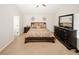 King-size bed in a well-lit bedroom with neutral tones and a dresser at 208 Magnaview Dr, Mcdonough, GA 30253