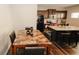 Kitchen dining area with granite-top island and table for six at 208 Magnaview Dr, Mcdonough, GA 30253