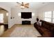 Spacious living room with plush brown sofas and a large TV at 208 Magnaview Dr, Mcdonough, GA 30253