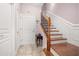 Inviting entryway with tile flooring, coat closet, and elegant staircase at 2827 Overlook Ne Trce, Atlanta, GA 30324