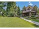 Exterior view of a landscaped backyard featuring a manicured lawn, walkway and covered outdoor pavillion at 2827 Overlook Ne Trce, Atlanta, GA 30324