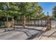 View of the gated entrance to the property featuring decorative brick and stone pillars and a black wrought iron gate at 2827 Overlook Ne Trce, Atlanta, GA 30324