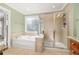 Main bathroom featuring a soaking tub and walk in shower at 2827 Overlook Ne Trce, Atlanta, GA 30324