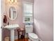 Light and airy powder room with pedestal sink and toilet at 2827 Overlook Ne Trce, Atlanta, GA 30324