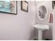 Well-appointed powder room with pedestal sink and elegant mirror at 2827 Overlook Ne Trce, Atlanta, GA 30324