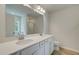 Double vanity bathroom with a shower and linen closet at 328 Navigator Ln, Mcdonough, GA 30253