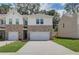 Two-story brick townhome with a two-car garage and landscaped front yard at 328 Navigator Ln, Mcdonough, GA 30253