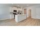 Modern white kitchen with stainless steel appliances and a large island at 328 Navigator Ln, Mcdonough, GA 30253