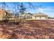 House with large backyard, mostly covered in autumn leaves at 341 Harris Ave, Locust Grove, GA 30248