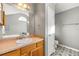 Bathroom with wood vanity, large mirror, and geometric tile floor at 341 Harris Ave, Locust Grove, GA 30248