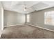 Large bedroom with neutral walls, carpet, and ceiling fan at 341 Harris Ave, Locust Grove, GA 30248