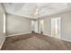 Main bedroom with neutral walls, carpet, and access to bathroom and closet at 341 Harris Ave, Locust Grove, GA 30248