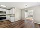 Dining area with hardwood floors and sunroom access at 341 Harris Ave, Locust Grove, GA 30248