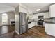 Kitchen with stainless steel appliances and white cabinets at 341 Harris Ave, Locust Grove, GA 30248