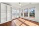 Sunroom with built-in shelving and hardwood floors at 341 Harris Ave, Locust Grove, GA 30248