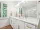 Double vanity bathroom with a large mirror and marble shower at 475 Rose Garden Ln, Alpharetta, GA 30009