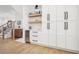 Bright butler's pantry with white cabinets, wine cooler, and open shelving at 475 Rose Garden Ln, Alpharetta, GA 30009