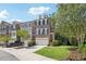 Townhome exterior showcasing brick facade, landscaping, and driveway at 475 Rose Garden Ln, Alpharetta, GA 30009