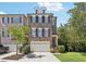 Brick front of charming townhome with attached garage and manicured lawn at 475 Rose Garden Ln, Alpharetta, GA 30009