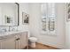 Light and bright powder room with a wood vanity and marble countertop at 475 Rose Garden Ln, Alpharetta, GA 30009