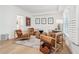 Sitting area with hardwood floors, leather chairs, and a large window at 475 Rose Garden Ln, Alpharetta, GA 30009