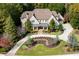 Luxury home with a large driveway and landscaped yard at 923 Little Darby Ln, Suwanee, GA 30024