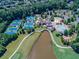 Aerial view of community with pool, tennis courts, playground, and clubhouse at 923 Little Darby Ln, Suwanee, GA 30024