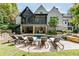 Stunning backyard pool area with a covered patio, outdoor seating, and beautiful landscaping at 923 Little Darby Ln, Suwanee, GA 30024
