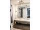 A modern bathroom featuring a double sink vanity, gold mirror, and stylish decor at 923 Little Darby Ln, Suwanee, GA 30024