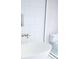 Relaxing bathroom with standalone tub, framed with white tiles and glass door at 923 Little Darby Ln, Suwanee, GA 30024