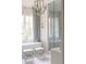 Bright bathroom featuring a soaking tub, modern fixtures, and frameless glass shower at 923 Little Darby Ln, Suwanee, GA 30024