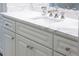 Bathroom vanity featuring white marble countertops and custom cabinetry with round knobs at 923 Little Darby Ln, Suwanee, GA 30024