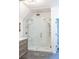 Beautiful bathroom featuring frameless glass shower, rainfall shower heads, and custom tile work at 923 Little Darby Ln, Suwanee, GA 30024
