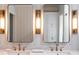 Elegant bathroom featuring dual sinks, marble countertop, and modern lighting fixtures at 923 Little Darby Ln, Suwanee, GA 30024