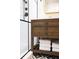 Rustic bathroom vanity with sleek fixtures and ample storage, complemented by stylish tile flooring at 923 Little Darby Ln, Suwanee, GA 30024