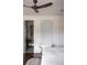 Bright bedroom featuring a ceiling fan and a stylish stool near the bed, adding comfort and style at 923 Little Darby Ln, Suwanee, GA 30024