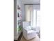 Cozy reading nook by the window with an upholstered arm chair and convenient shelving at 923 Little Darby Ln, Suwanee, GA 30024
