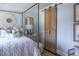 Stylish bedroom showcasing a four-poster bed, sliding door and patterned wallpaper at 923 Little Darby Ln, Suwanee, GA 30024