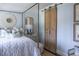 Charming bedroom with a four-poster bed, blue patterned wallpaper and barn door at 923 Little Darby Ln, Suwanee, GA 30024