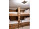 Cozy bunk room featuring rustic wooden beds, a ladder, and stylish lighting for a comfortable retreat at 923 Little Darby Ln, Suwanee, GA 30024