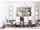 Formal dining room with large chandelier and mirror at 923 Little Darby Ln, Suwanee, GA 30024