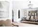 Open-concept dining room with modern chandelier and seating for six guests at 923 Little Darby Ln, Suwanee, GA 30024