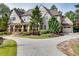 Home featuring a long driveway, well-manicured lawn, and mature landscaping at 923 Little Darby Ln, Suwanee, GA 30024