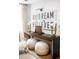 A stylish entryway with a console table, modern lamps, and comfortable ottomans for a welcoming ambiance at 923 Little Darby Ln, Suwanee, GA 30024