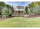 Beautiful home exterior with manicured lawn, mature trees, and elegant landscaping at 923 Little Darby Ln, Suwanee, GA 30024