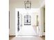 Bright foyer with a long hallway, hardwood floors, and elegant lighting fixtures at 923 Little Darby Ln, Suwanee, GA 30024
