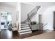 Foyer with hardwood floors, staircase, and decorative furniture at 923 Little Darby Ln, Suwanee, GA 30024