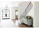 Hallway with hardwood floors, elegant decor, and staircase with iron railing at 923 Little Darby Ln, Suwanee, GA 30024
